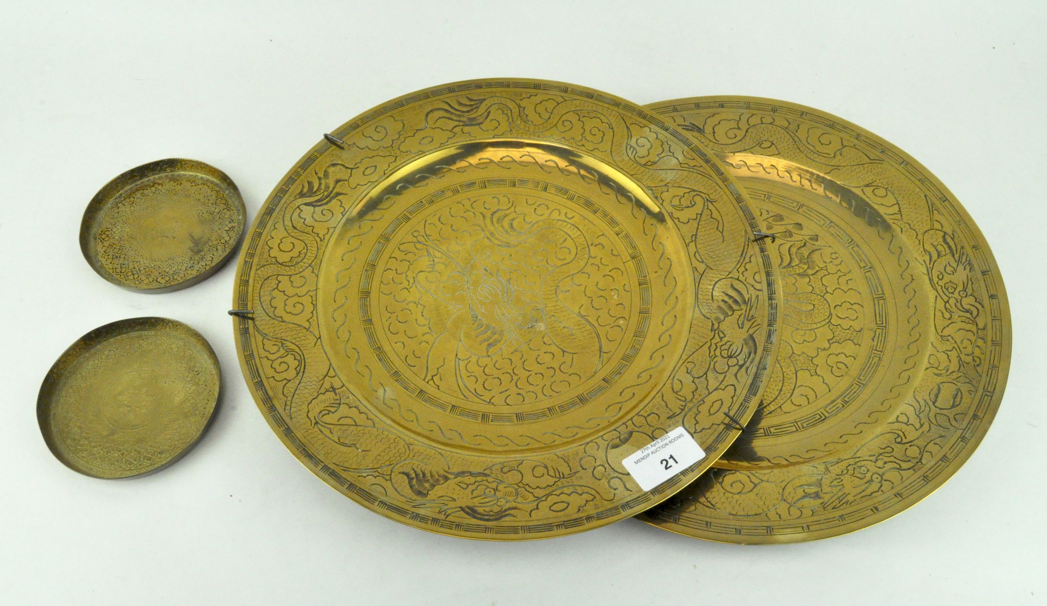 Two Chinese brass/bronze dishes engraved with dragons and two coasters,