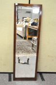 A rectangular oak framed mirror with bevelled edge,