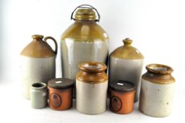 A collection of brown saltglaze stoneware flagons and storage jars in sizes, 20th century,