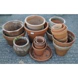 A large collection of assorted plant pots, including terracotta examples,