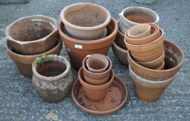 A large collection of assorted plant pots, including terracotta examples,