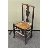 An oak dining chair, 20th century, with vase-shaped split and inset seat, on turned legs,