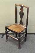 An oak dining chair, 20th century, with vase-shaped split and inset seat, on turned legs,
