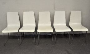 A set of five painted dining chairs, on chrome supports,