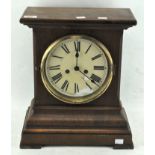 A Victorian mantel clock in a mahogany case, the dial with Roman numerals denoting hours,