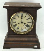 A Victorian mantel clock in a mahogany case, the dial with Roman numerals denoting hours,