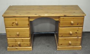 A pine twin pedestal desk, each side with three drawers,