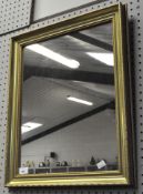 A gilt framed mirror of rectangular section,