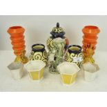 A collection of pottery vases, a frog candlestick,