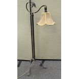 A wrought iron telescopic lamp, raised on tripod base,