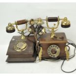 Two vintage telephones, in wood and brass,
