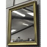 A gilt framed mirror of rectangular section,