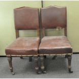 A pair of leatherette upholstered dining chairs, made by Gillows,