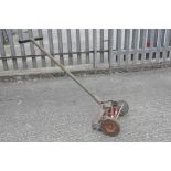 A vintage lawn mower by Qualcast,