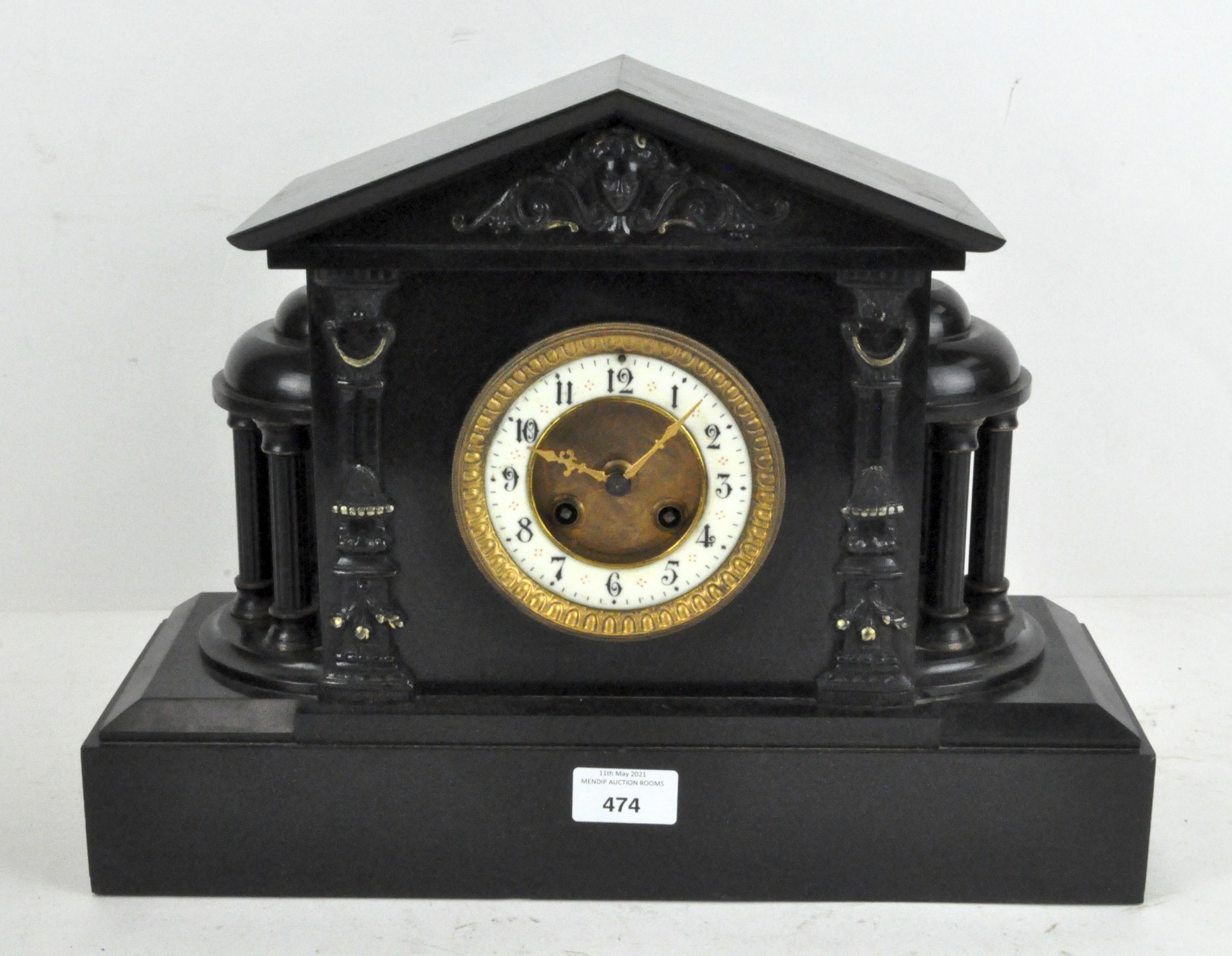 A Victorian black marble clock, French, striking to a bell,