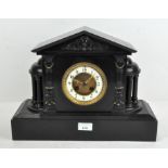 A Victorian black marble clock, French, striking to a bell,