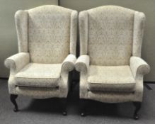 A pair of floral upholstered armchairs,