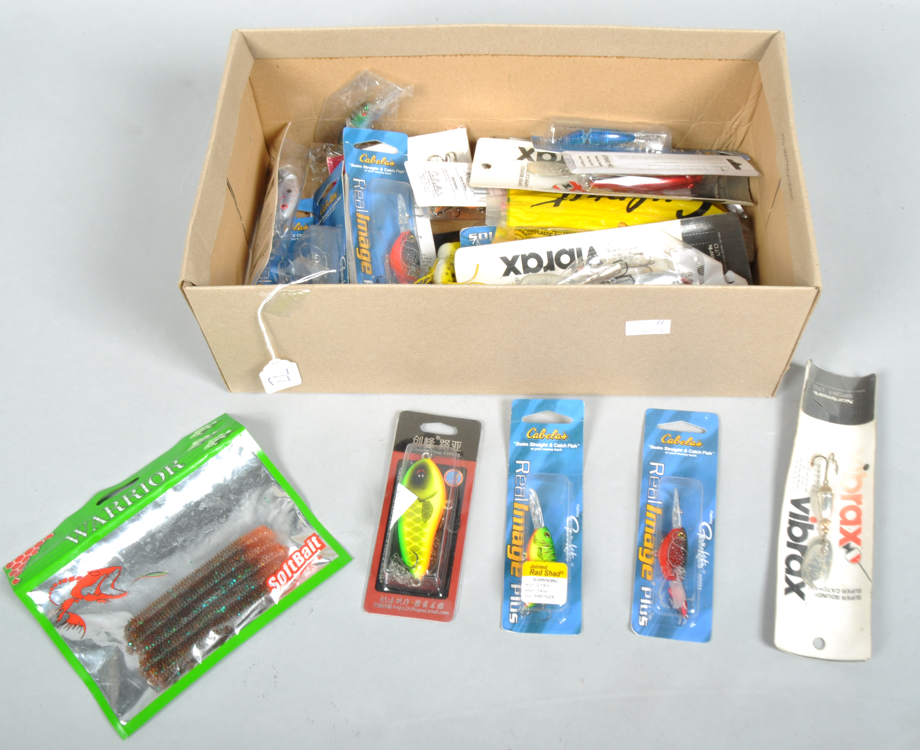 A box of approximately 25 new fishing lures,