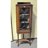 A George III style mahogany corner cabinet,, enclosing three shelves,