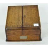 A Victorian oak stationery cabinet, with hinged double front revealing fitted interior,