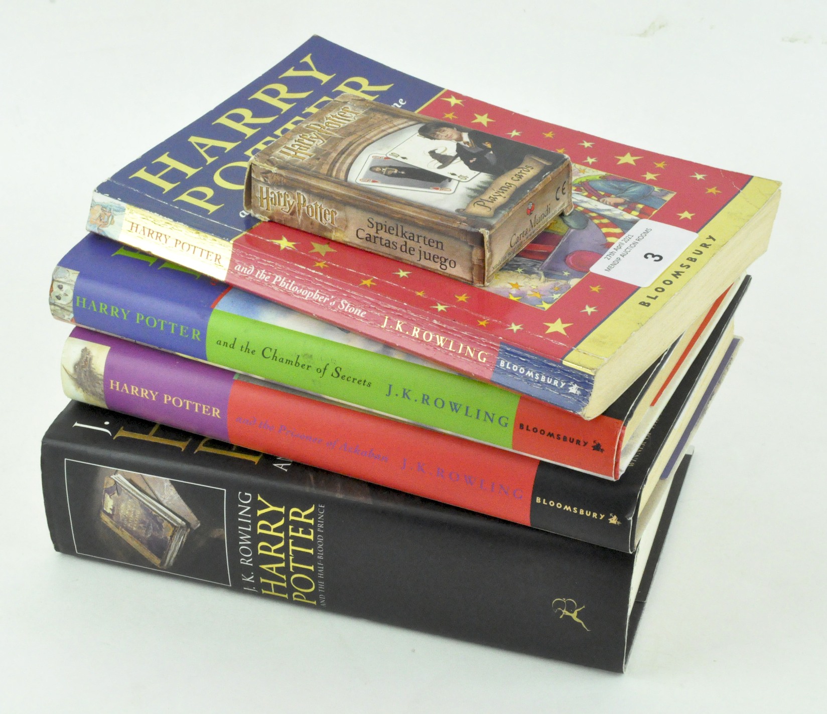 Four Harry Potter books, comprising: a softback 'The Philosopher's Stone',