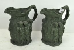 A pair of relief-moulded stoneware jugs,