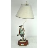 A Continental porcelain figure of a Town Crier, mounted as a table lamp,