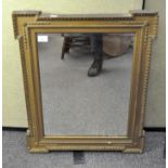 A gilt wall mirror of rectangular form, foliate borders,