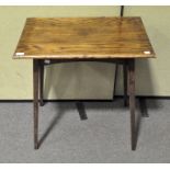 An oak side table, 20th century, on tapering slender legs,