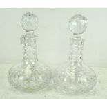 A pair of cut glass decanters of squat form, with original stoppers,