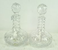 A pair of cut glass decanters of squat form, with original stoppers,