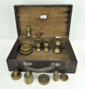 A quantity of brass scale weights in wooden cases,