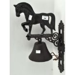 A metal wall mounting bell in the form of a horse
