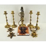 A collection of brass candlesticks, including four matching examples,