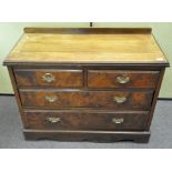 A Walnut veneered chest of drawers, two short over two long drawers,