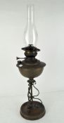 An early 20th century brass oil lamp by Veritas, with original glass funnel,