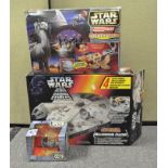 A collection of Star Wars toys, including an Electronic Millennium Falcon,