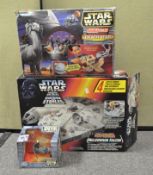 A collection of Star Wars toys, including an Electronic Millennium Falcon,