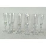 Ten French glass champagne flutes the stems moulded as two birds,