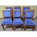Six contemporary dining chairs with blue upholstered backs and seats,