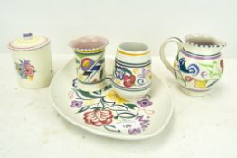 Five pieces of Poole pottery, to include milk jug,
