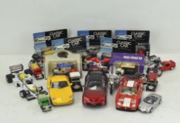 A collection of die cast vehicles, including boxed Classic car models,