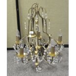 A five branch gilt metal chandelier, with glass drops,