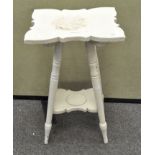 A white painted occasional table, raised on four turned graduating legs,