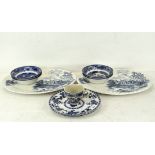 A blue and white part service in the willow pattern,