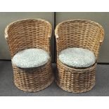 A pair of wicker tub chairs, with William Morris style Willow pattern cushions,