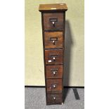 A wooden tall narrow six drawer storage unit and contents, mainly sewing related,