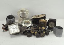 An assortment of clock movements and mechanisms, some with dials,
