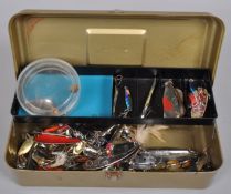 A metal tackle box containing heavy duty spoons,