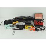 A collection of compact cameras, including a Canon sure shot AF-7,